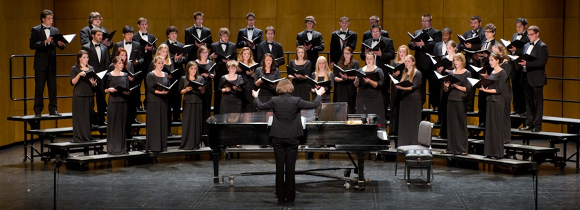Buffalo State Chamber Choir performing on stage under the direction of Dr. Victoria Furby