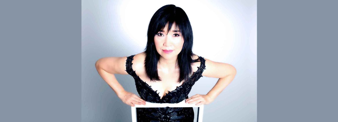 Keiko Matsui leaning over the back of a chair