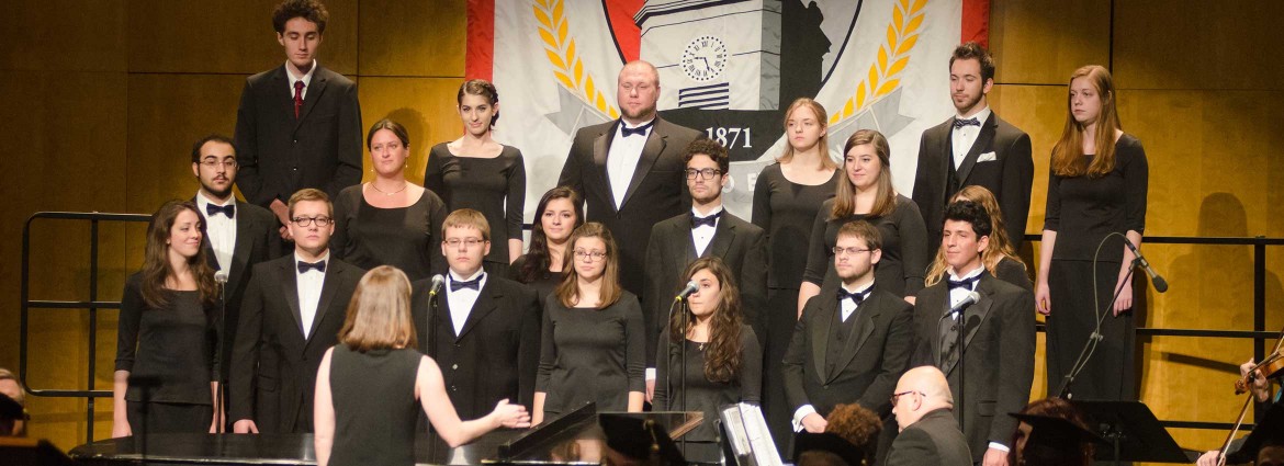 Members of the Buffalo State Chamber Choir performing on stage.