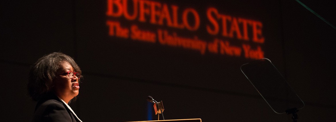 President Katherine Conway-Turner addressing the crowd with the Buffalo State logo in the background