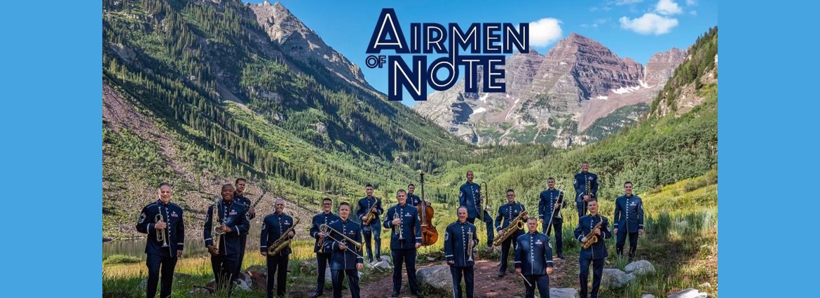 Airmen with instruments in front of mountain
