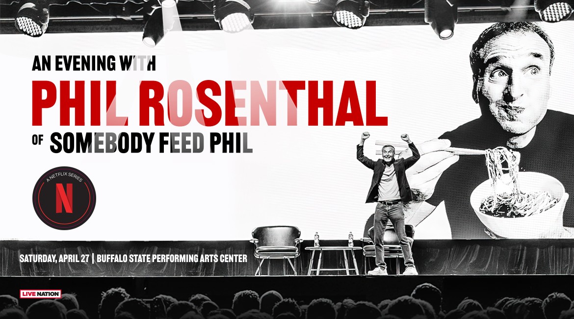 Phil Rosenthal on stage with hands in air